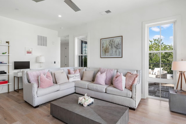 living area with recessed lighting, visible vents, and light wood-style floors