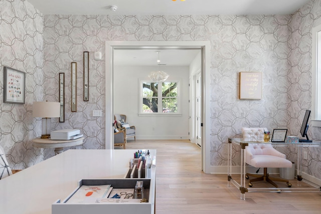 kitchen with wood finished floors, baseboards, and wallpapered walls