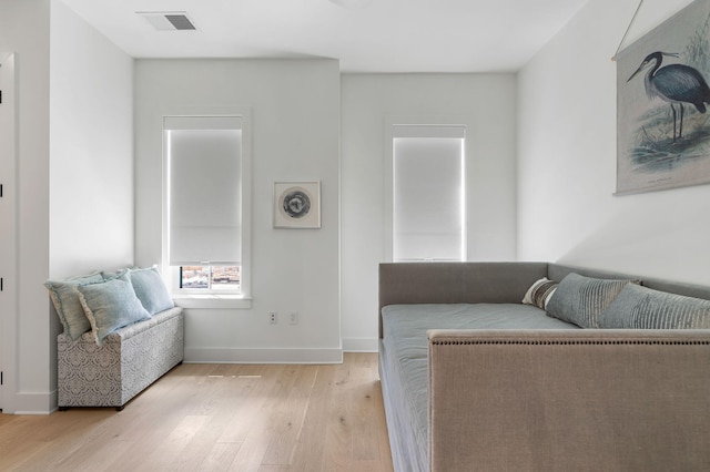 interior space featuring light wood-type flooring, visible vents, and baseboards