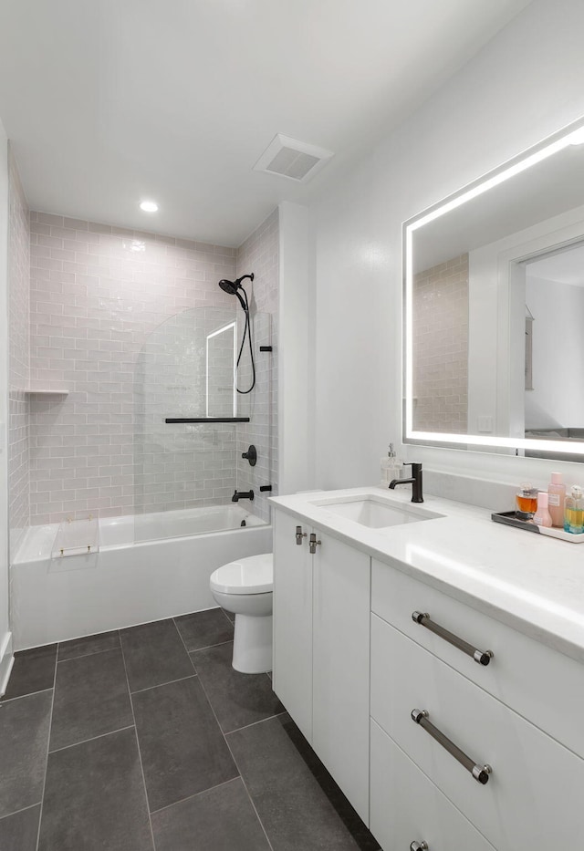 bathroom with visible vents, toilet, tile patterned floors, vanity, and shower / bathing tub combination