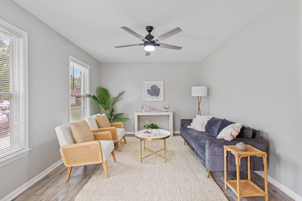 living room with wood-type flooring, a healthy amount of sunlight, and ceiling fan