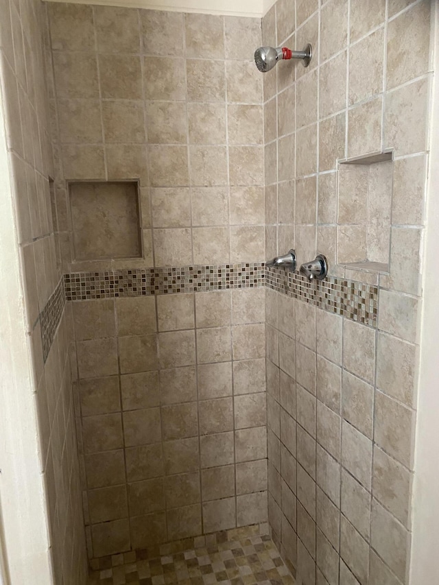 bathroom with a tile shower