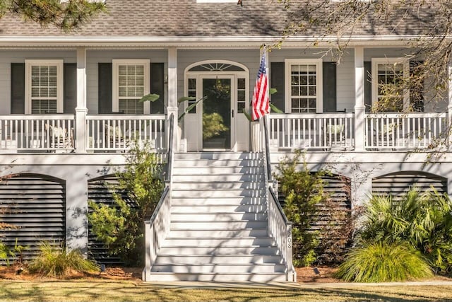 doorway to property with a shingled roof