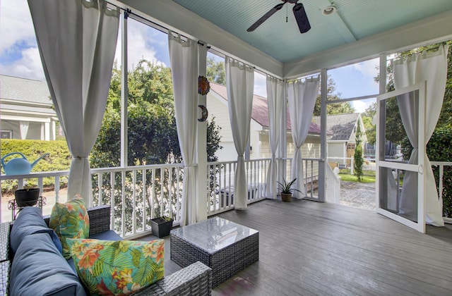 sunroom / solarium featuring ceiling fan