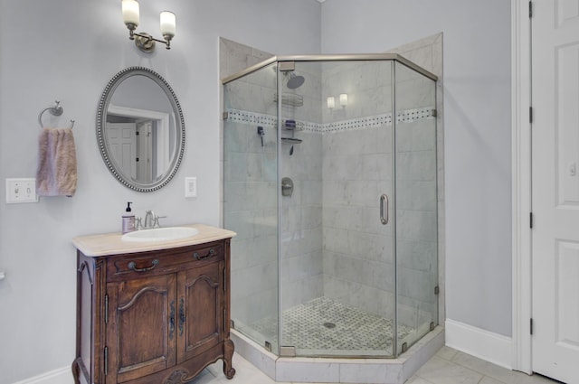 full bath featuring vanity, baseboards, and a stall shower