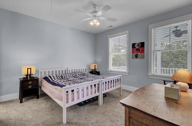 bedroom with visible vents, baseboards, carpet flooring, and ceiling fan