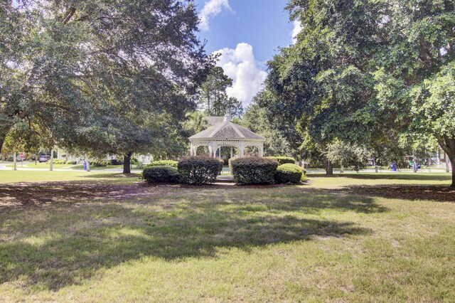 view of community with a gazebo and a yard