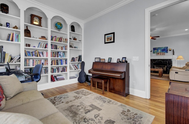 office area featuring ornamental molding, a premium fireplace, and wood finished floors