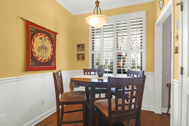 dining room with wainscoting and dark wood-style flooring