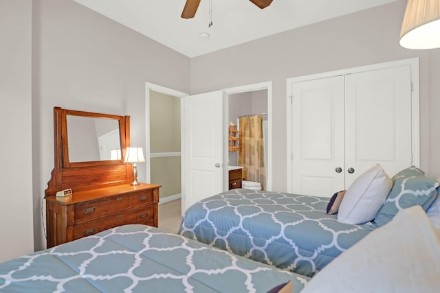 carpeted bedroom with a closet, ensuite bath, and a ceiling fan