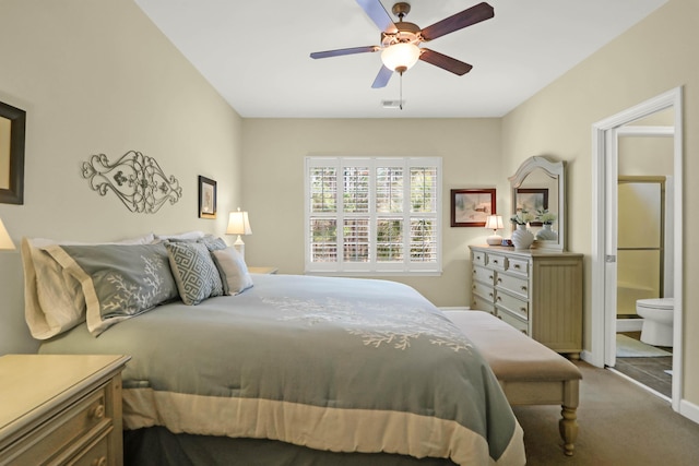 carpeted bedroom featuring visible vents, ensuite bathroom, and ceiling fan