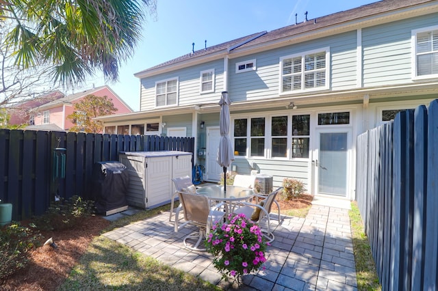 rear view of property with a patio area and fence