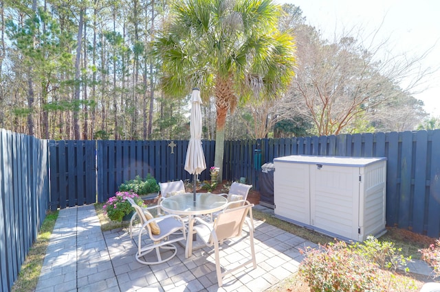 view of patio / terrace featuring outdoor dining area, a fenced backyard, and a hot tub