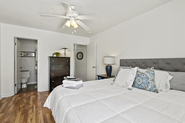 bedroom featuring ensuite bathroom, a ceiling fan, baseboards, and wood finished floors