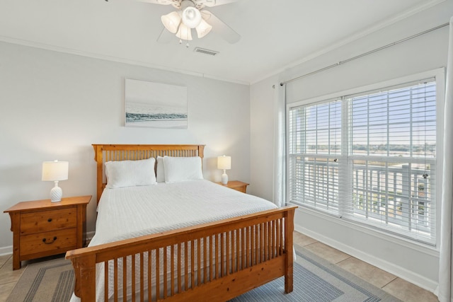 bedroom with light tile patterned floors, baseboards, visible vents, a ceiling fan, and ornamental molding