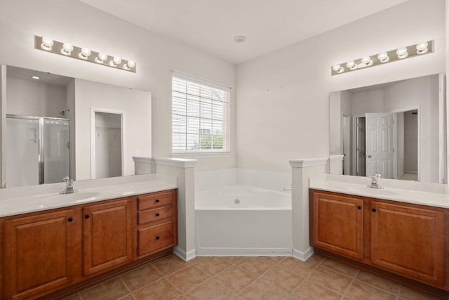 bathroom featuring tile patterned floors, vanity, and separate shower and tub