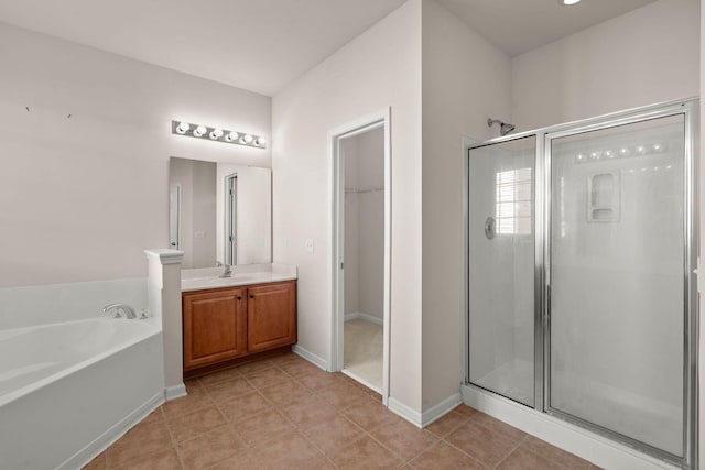 bathroom featuring vanity, tile patterned floors, and shower with separate bathtub