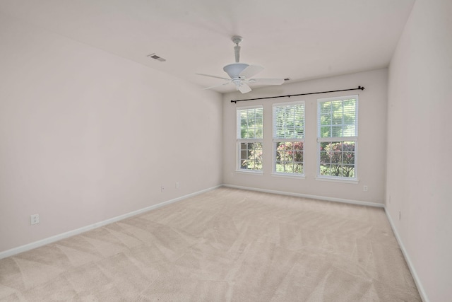 empty room featuring light carpet and ceiling fan