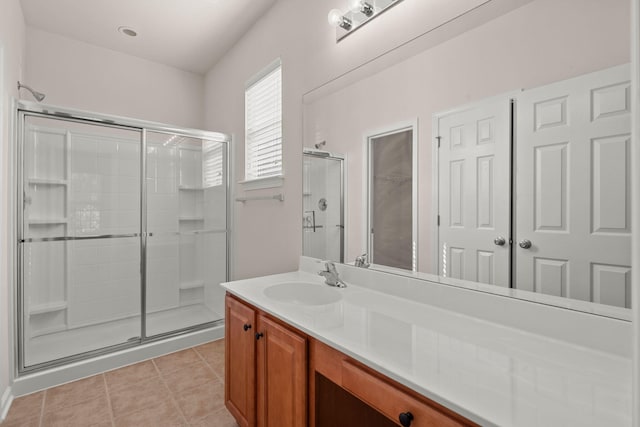 bathroom featuring vanity, tile patterned floors, and walk in shower