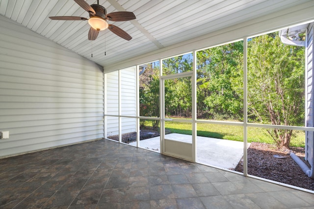 unfurnished sunroom featuring lofted ceiling and ceiling fan