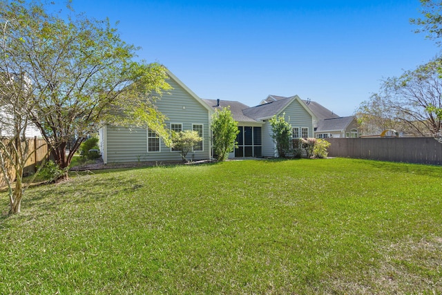 rear view of property with a lawn