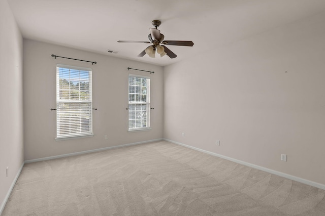 carpeted spare room with ceiling fan