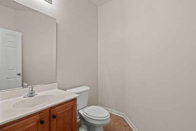 bathroom featuring vanity, toilet, and tile patterned flooring