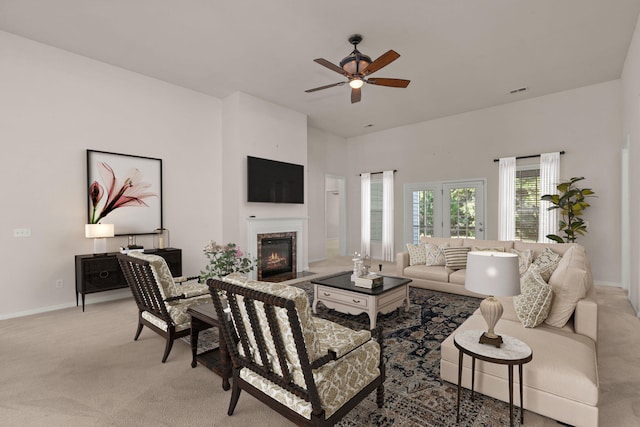 carpeted living room with ceiling fan