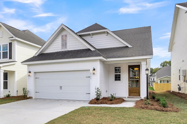 view of front of house with driveway, a garage, and roof with shingles