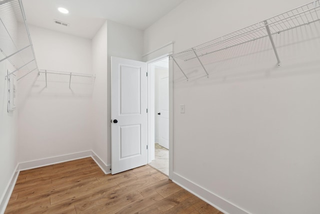 walk in closet featuring visible vents and light wood finished floors