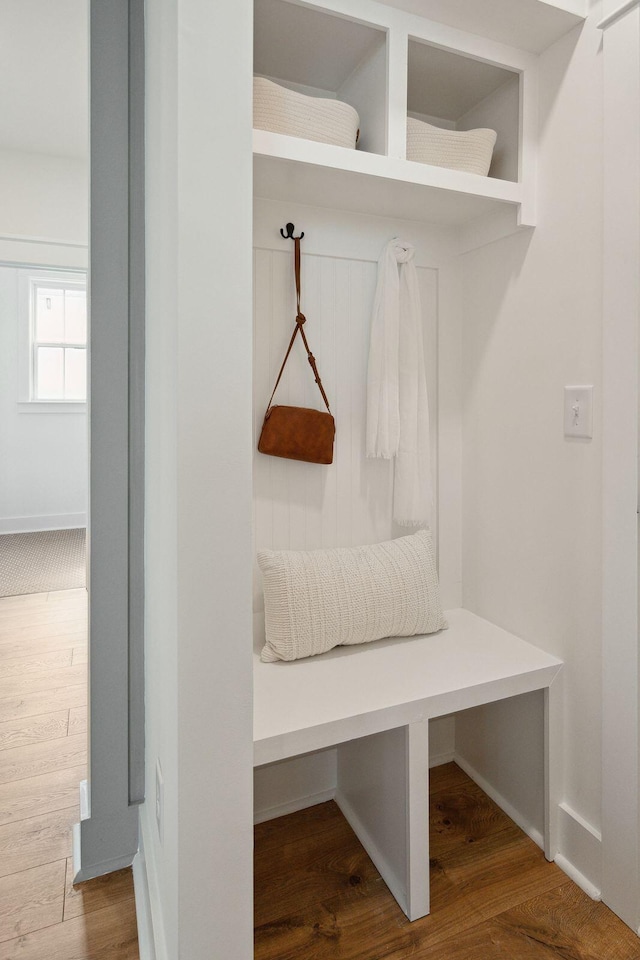 mudroom with wood finished floors and baseboards