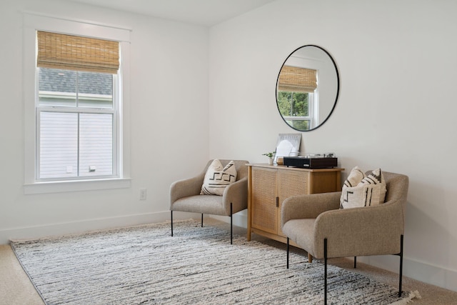 sitting room featuring carpet flooring and baseboards