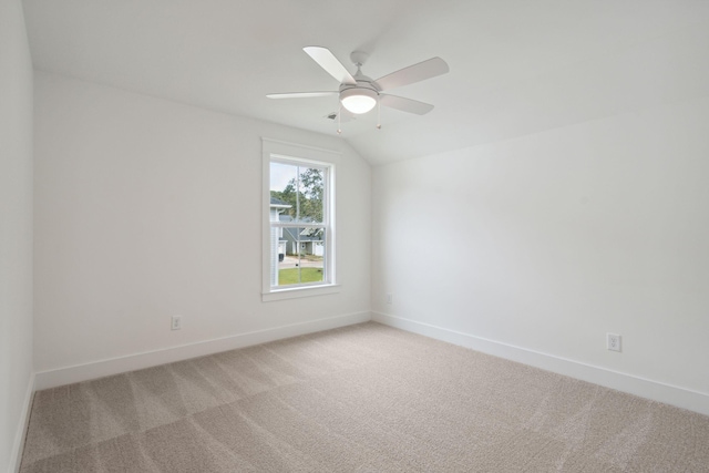 empty room with a ceiling fan, light colored carpet, and baseboards