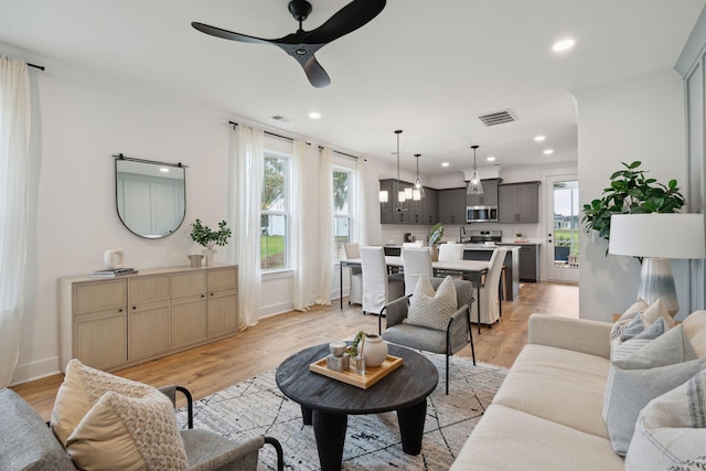 living room with recessed lighting, visible vents, ceiling fan, and plenty of natural light