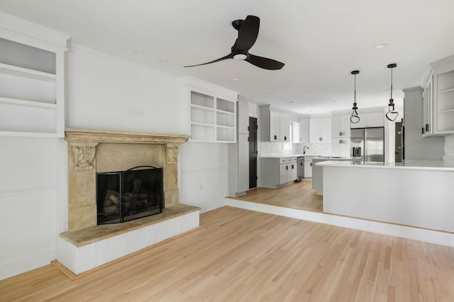 1019 Royalist Rd, Mount Pleasant, SC 29464 - unfurnished living room featuring a ceiling fan, light wood-style flooring, and a fireplace