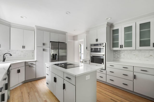 1019 Royalist Rd, Mount Pleasant, SC 29464 - kitchen featuring appliances with stainless steel finishes, a sink, tasteful backsplash, a center island, and light countertops