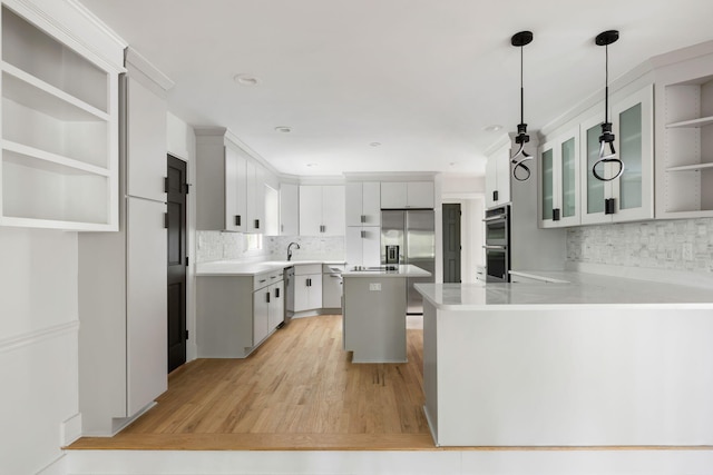 1019 Royalist Rd, Mount Pleasant, SC 29464 - kitchen featuring stainless steel appliances, a peninsula, backsplash, open shelves, and recessed lighting