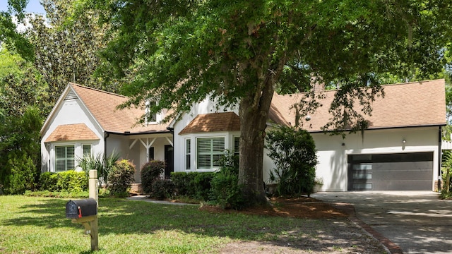 1019 Royalist Rd, Mount Pleasant, SC 29464 - view of front of property with stucco siding, driveway, a front yard, roof with shingles, and an attached garage