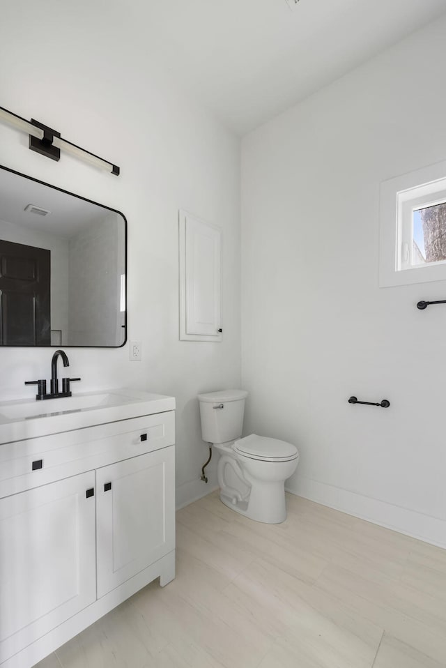 1019 Royalist Rd, Mount Pleasant, SC 29464 - bathroom with toilet, baseboards, and vanity