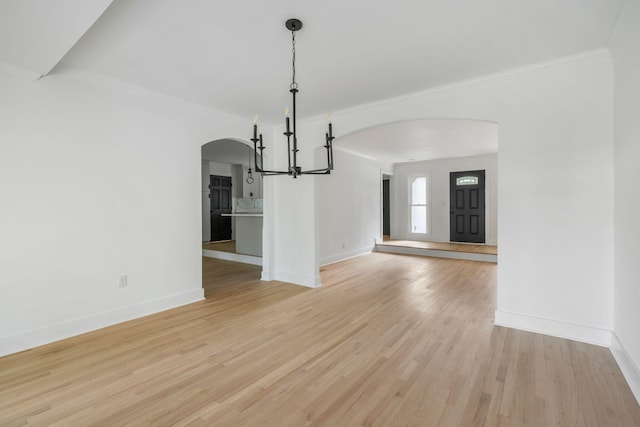 1019 Royalist Rd, Mount Pleasant, SC 29464 - unfurnished dining area with arched walkways, a chandelier, crown molding, baseboards, and light wood-style floors