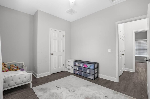 bedroom with dark wood-type flooring