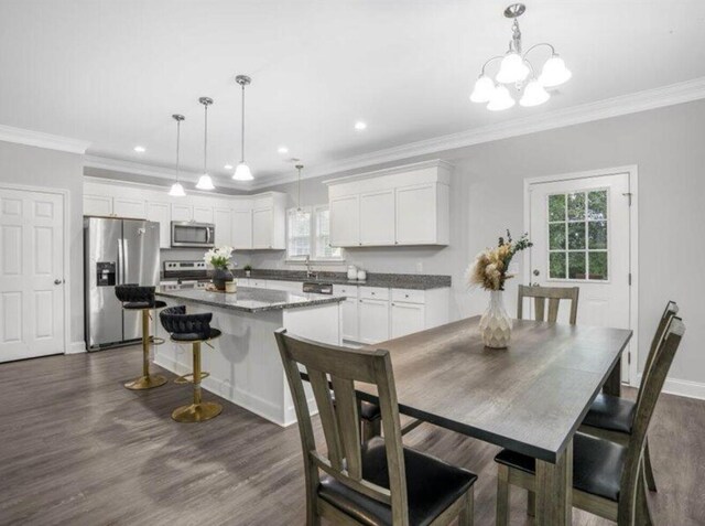 dining room featuring crown molding, dark hardwood / wood-style floors, and sink