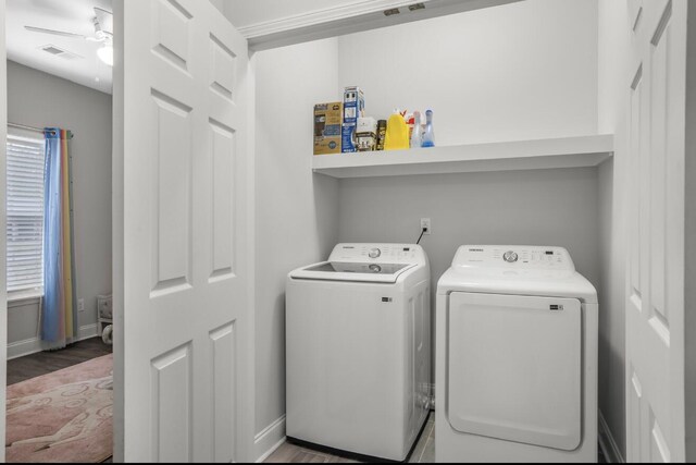 clothes washing area featuring hardwood / wood-style flooring, ceiling fan, and washer and dryer