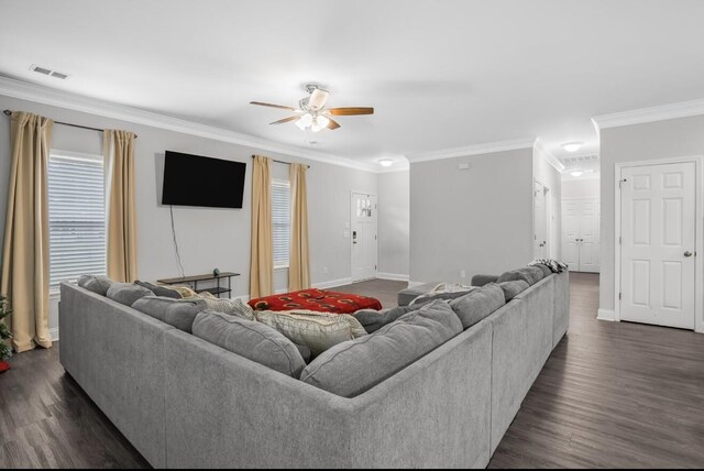 living room with dark wood-type flooring, ceiling fan, and ornamental molding