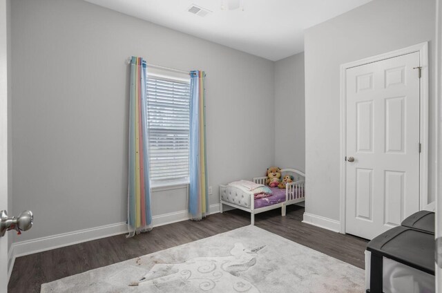 bedroom with dark hardwood / wood-style floors