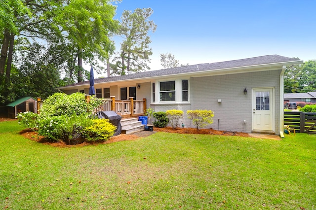 1416 Glencoe Dr, Mount Pleasant, SC 29464 - view of front facade featuring a deck, a storage unit, an outbuilding, and brick siding
