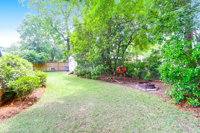 1416 Glencoe Dr, Mount Pleasant, SC 29464 - view of yard featuring an outdoor fire pit, a shed, and an outdoor structure
