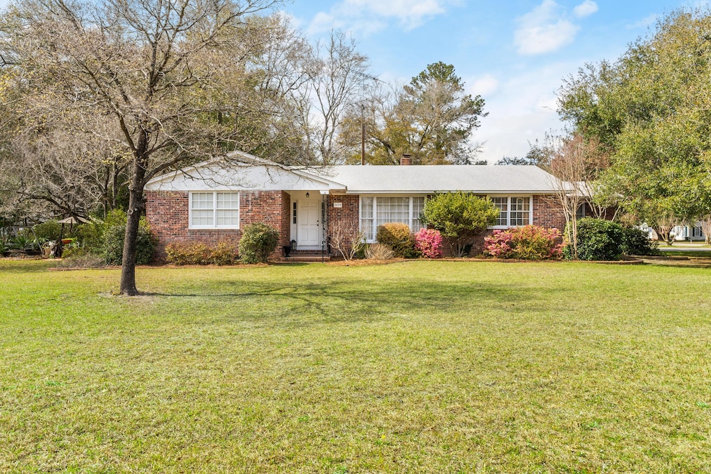 3634 Faust St, Bamberg, SC 29003 - ranch-style house with brick siding, a chimney, and a front lawn