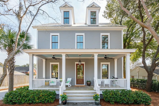 view of front facade featuring covered porch, ceiling fan, and fence