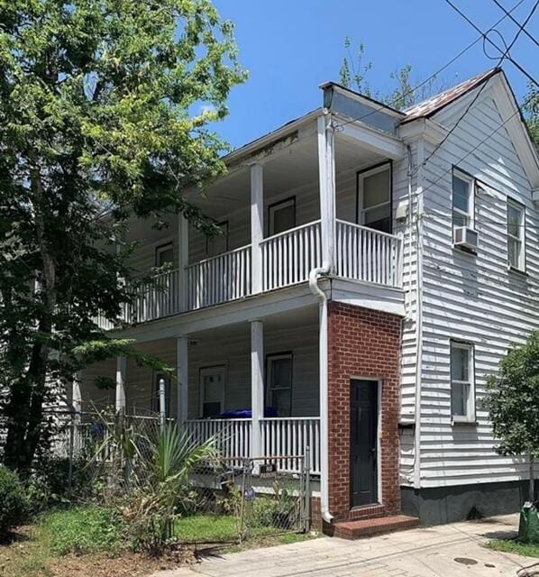 view of front of house featuring a porch and a balcony